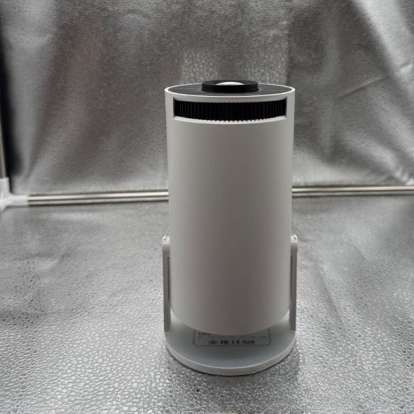Portable Mini Movie Projector standing upright with the lens aimed at the ceiling